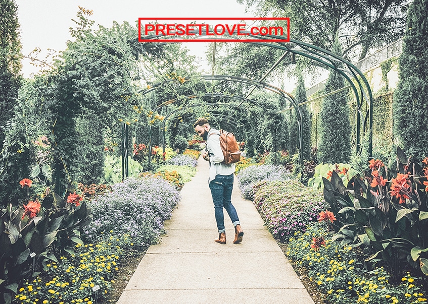 A vintage shot of a man strolling in a garden