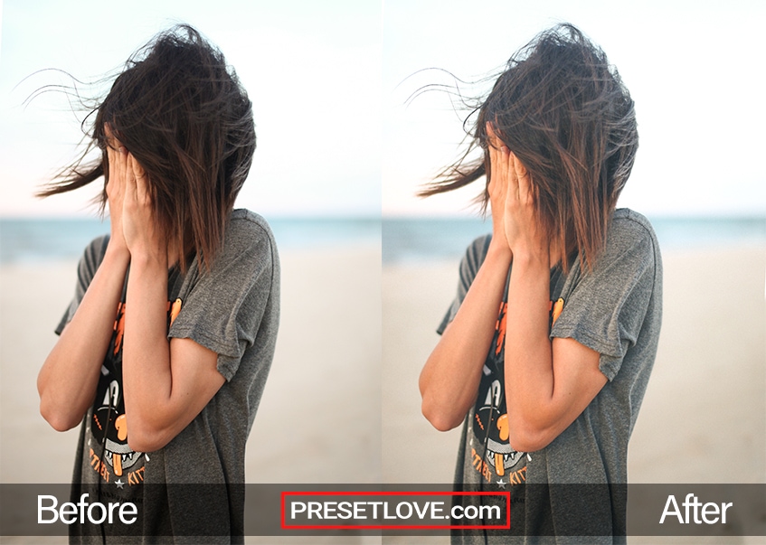An outdoor photo of a woman with covering her face with her hands