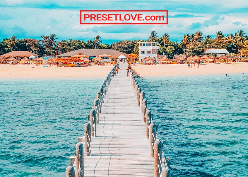 A vibrant and cinematic photo of a bridge to a beach