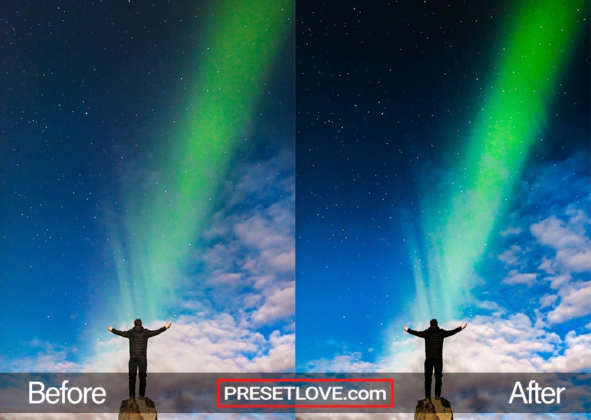 A man standing with outstretched arms in front of an Aurora streak