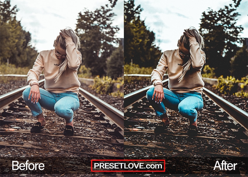 A dramatic photo of a woman squatting on a railroad track