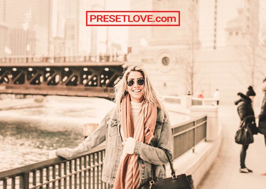 Warm Pastel travel photo of a woman wearing a coat and peach scarf