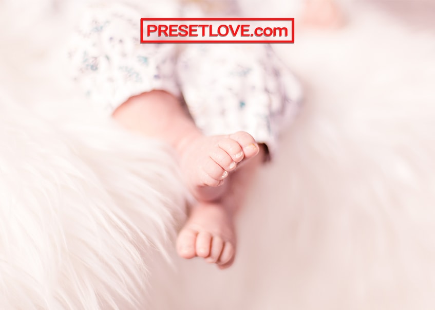 A warm and soft photo of a baby's feet