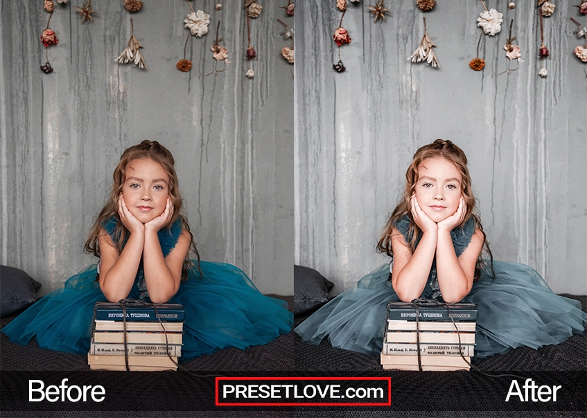 A little girl in a green dress with her hands under her chin