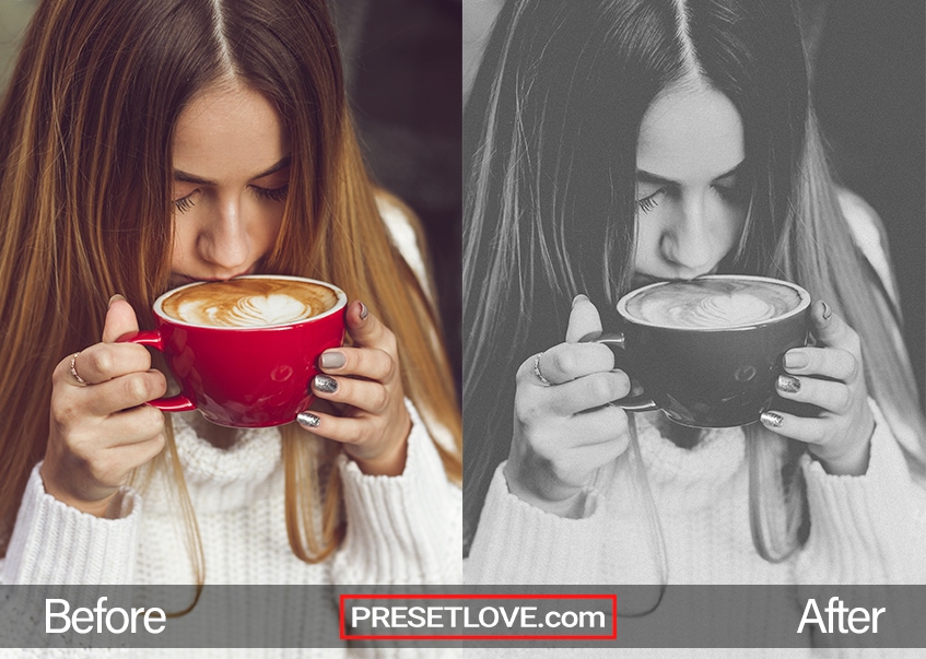 A light black and white photo of a woman sipping from a red mug of cappuccino