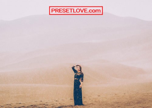 A soft and dramatic photo of a woman in a desert
