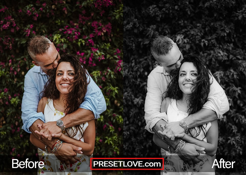 A smooth black and white portrait of a couple, with a bush in the background