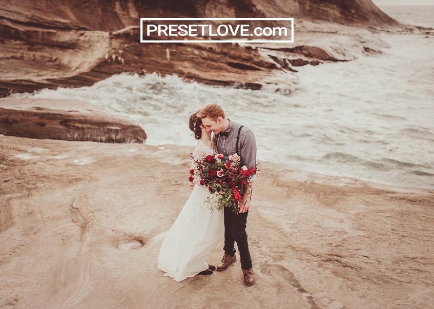 Warm vintage wedding photo of a couple by the beach